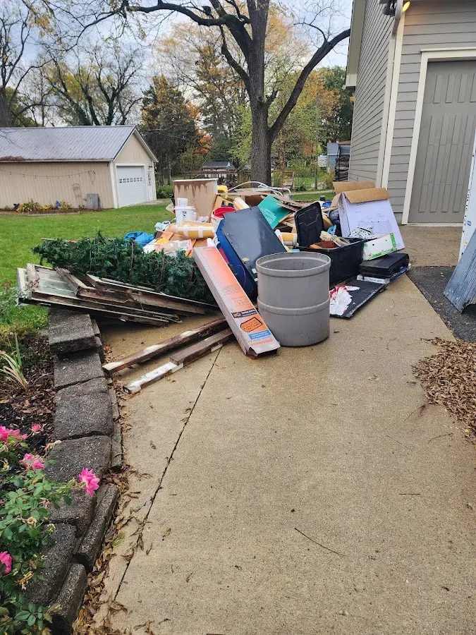 Dumpster being loaded with debris for Estate Cleanout Dumpster Rental in Keene